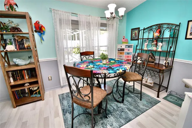 a view of a dining room with furniture and a window