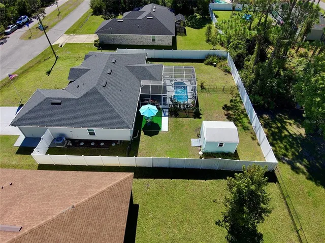 an aerial view of a house with a swimming pool
