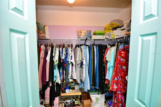 a bedroom with a bed a window and dresser