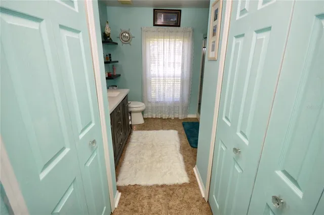 a bathroom with a toilet a sink and mirror