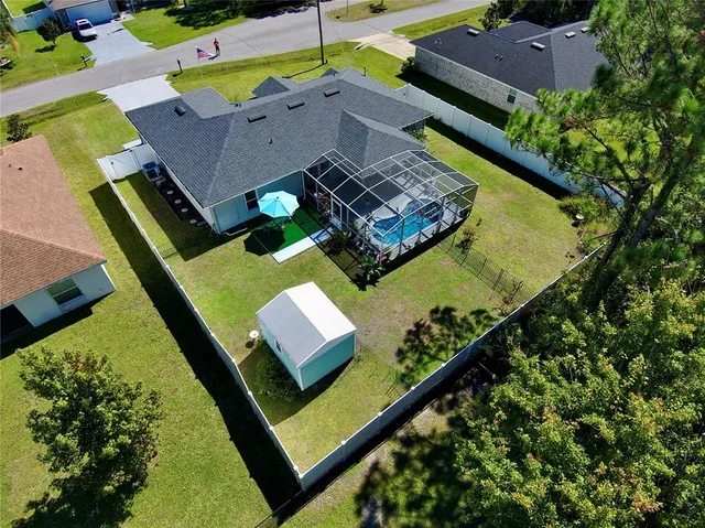an aerial view of a house with a garden and swimming pool