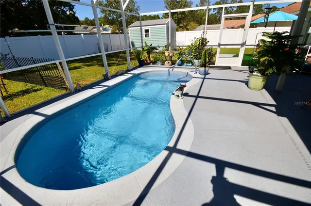 a view of a swimming pool with a patio