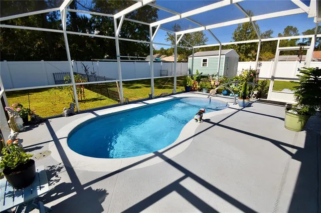 a view of a house with backyard sitting area and garden