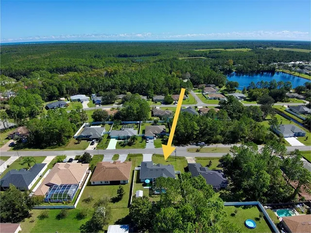 an aerial view of a house with a yard