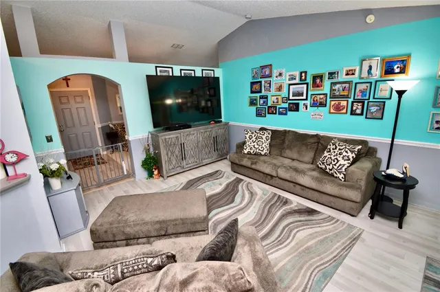 a living room with furniture and a flat screen tv