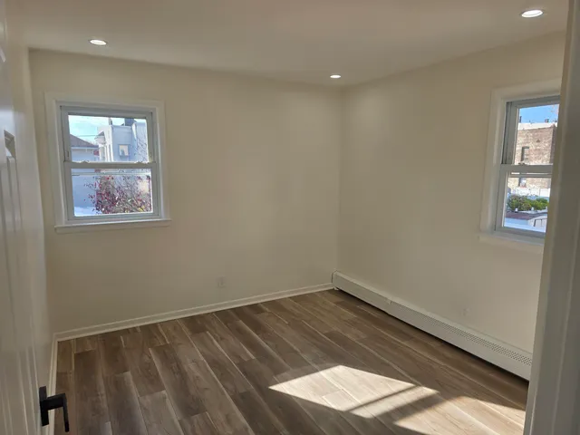 a view of wooden floor and windows in a room