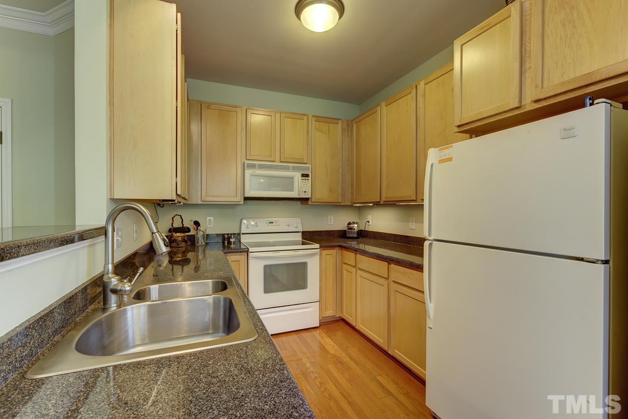 5410 Goldenglow Way Raleigh, NC 27606 - Photo 11 of 24 a kitchen with granite countertop a refrigerator sink and stove