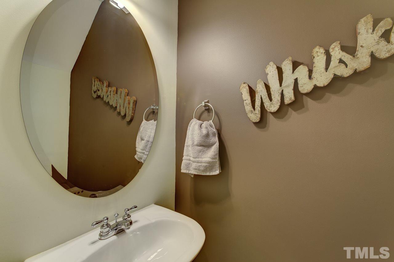 5410 Goldenglow Way Raleigh, NC 27606 - Photo 14 of 24 a bathroom with a sink and mirror