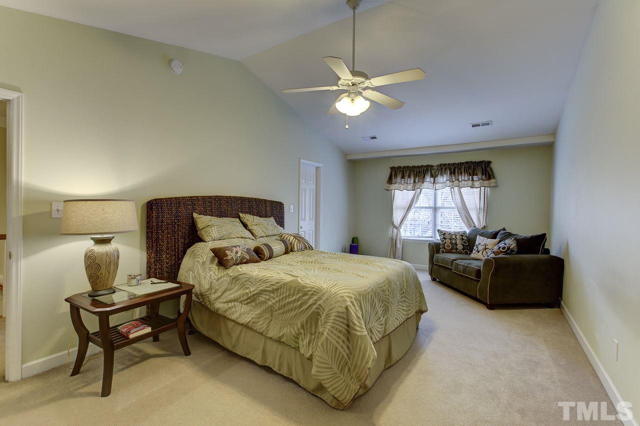 5410 Goldenglow Way Raleigh, NC 27606 - Photo 15 of 24 a bedroom with a bed and window