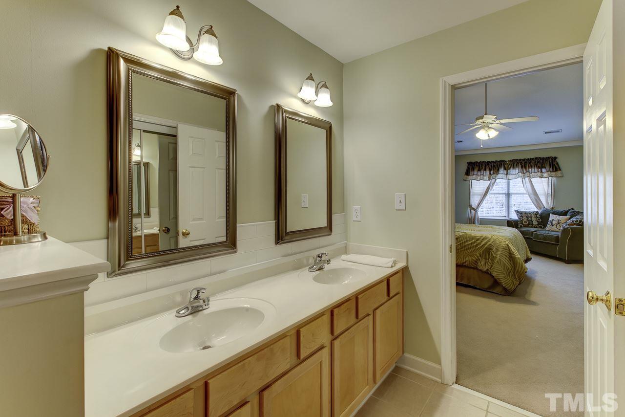 5410 Goldenglow Way Raleigh, NC 27606 - Photo 16 of 24 a en suite bathroom with a double vanity sink and a mirror