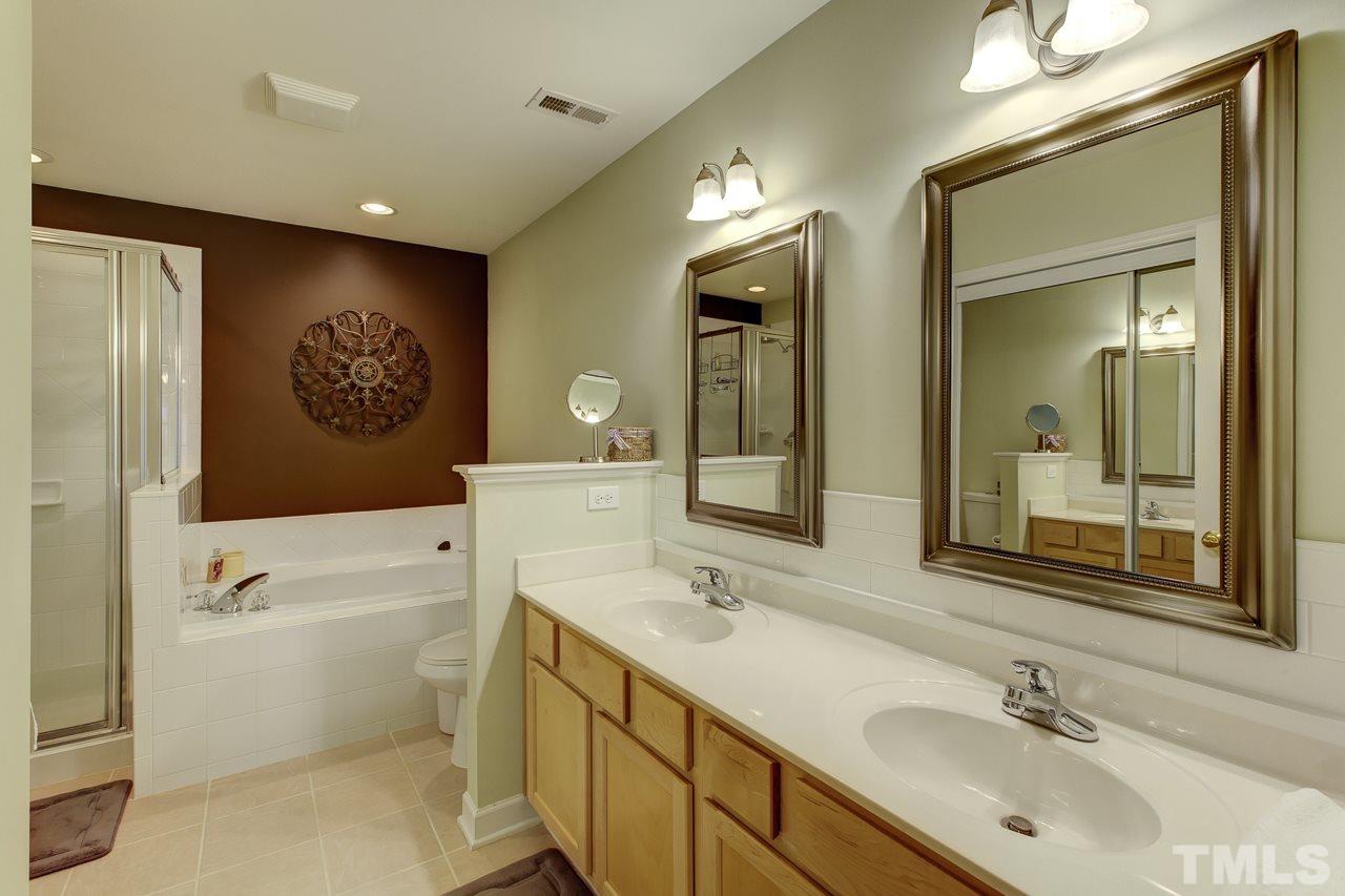 5410 Goldenglow Way Raleigh, NC 27606 - Photo 17 of 24 a bathroom with a sink a toilet and a mirror