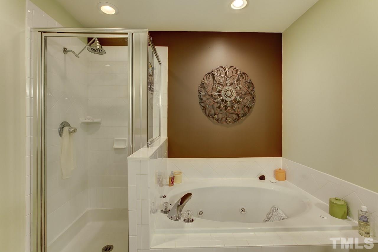 5410 Goldenglow Way Raleigh, NC 27606 - Photo 18 of 24 a bathroom with a bathtub and a shower