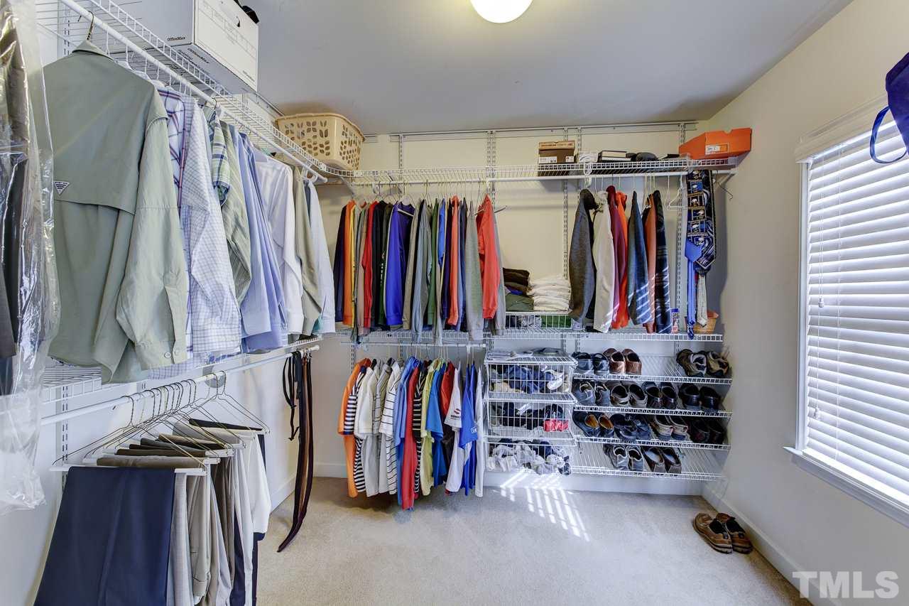 5410 Goldenglow Way Raleigh, NC 27606 - Photo 19 of 24 a view of walk in closet with clothes and shoes