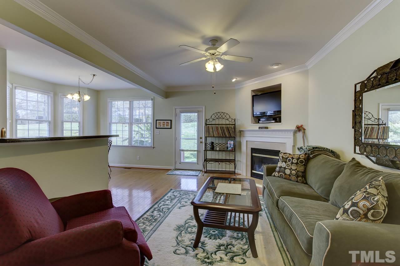 5410 Goldenglow Way Raleigh, NC 27606 - Photo 4 of 24 a living room with furniture a ceiling fan and a rug
