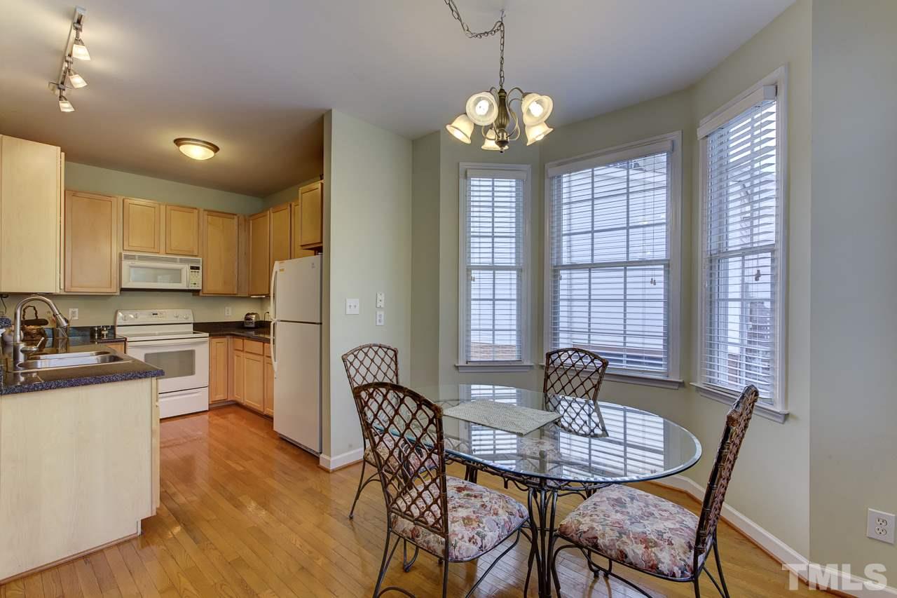 5410 Goldenglow Way Raleigh, NC 27606 - Photo 9 of 24 a view of a dining room with furniture window and wooden floor