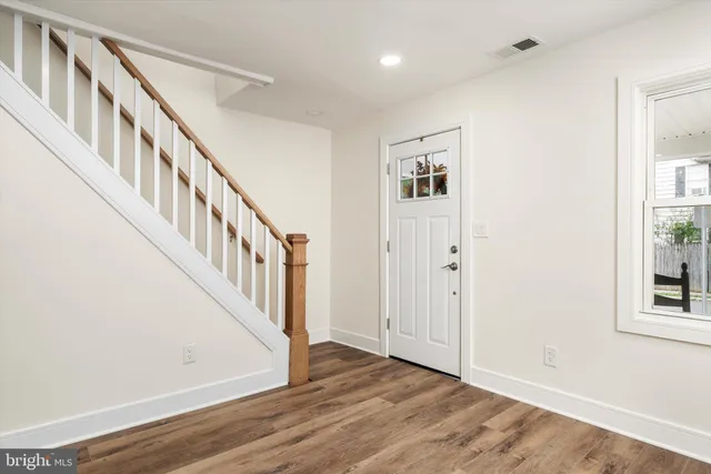 a view of an entryway with wooden floor