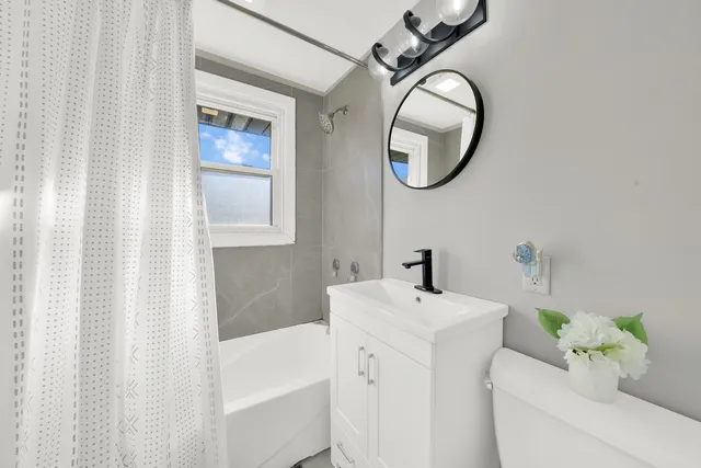 a bathroom with a sink toilet and a mirror
