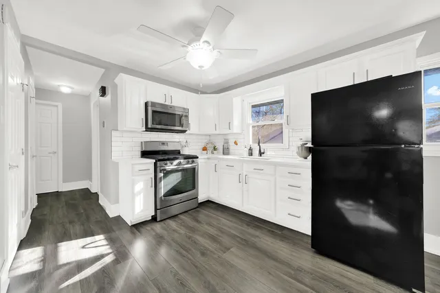 a kitchen with a refrigerator stove and microwave