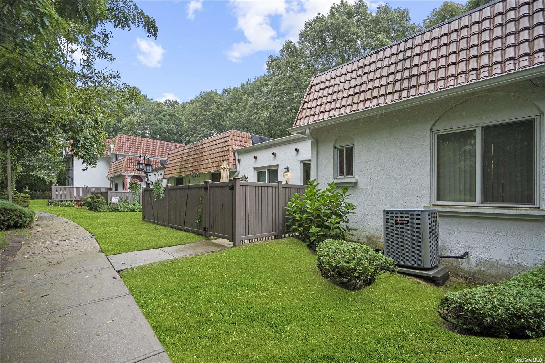 a view of a house with a yard and plants