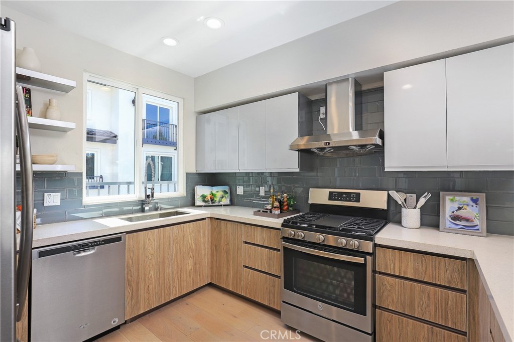 1 Spyglass Avenue Phillips Ranch, CA 91766 - Photo 15 of 63 a kitchen with cabinets appliances a sink and a window