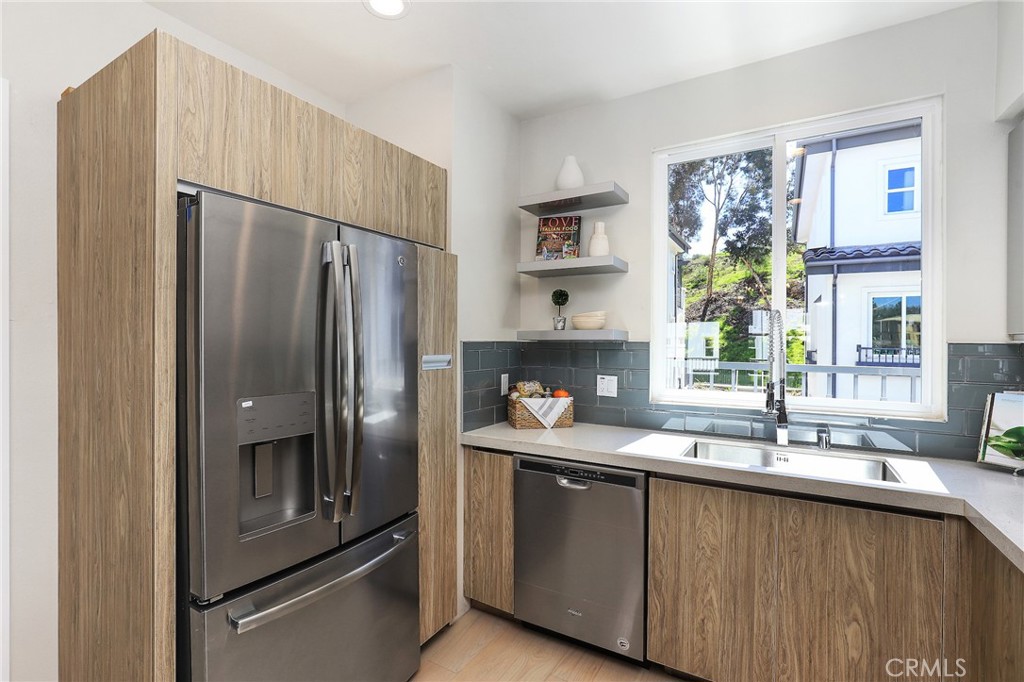 1 Spyglass Avenue Phillips Ranch, CA 91766 - Photo 17 of 63 a kitchen with granite countertop a refrigerator and a sink