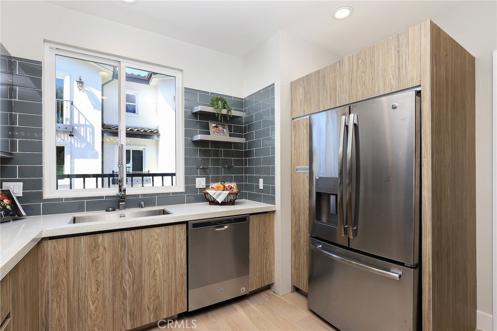 1 Spyglass Avenue Phillips Ranch, CA 91766 - Photo 39 of 63 a kitchen with stainless steel appliances a refrigerator and a sink