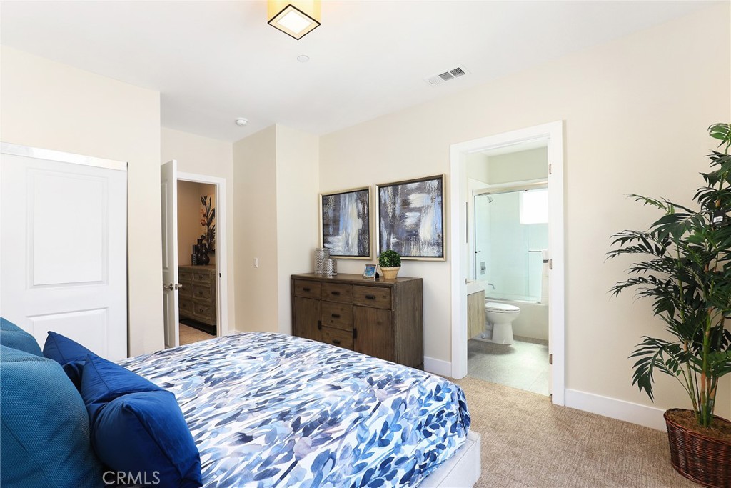 1 Spyglass Avenue Phillips Ranch, CA 91766 - Photo 44 of 63 a bedroom with a large bed and a potted plant