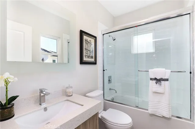 a view of pool with table and chairs under an umbrella