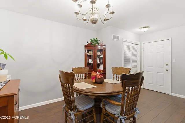 a view of a dining room with furniture wooden floor and chandelier