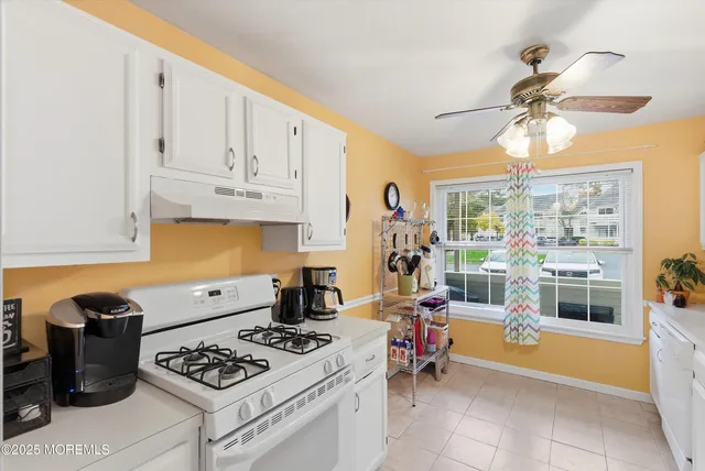 a kitchen with appliances a stove and a cabinets