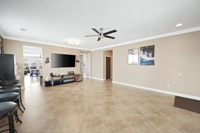 a view of a livingroom with a flat screen tv and couches with wooden floor