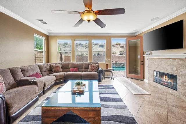 a living room with furniture a flat screen tv and a fireplace