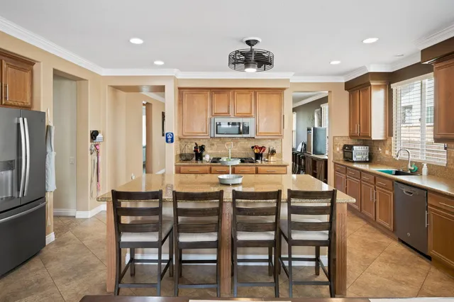 a large kitchen with a table and chairs