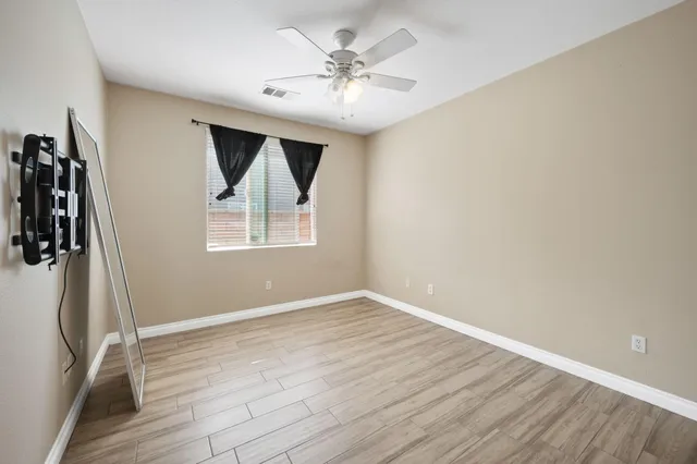 wooden floor in an empty room with a window