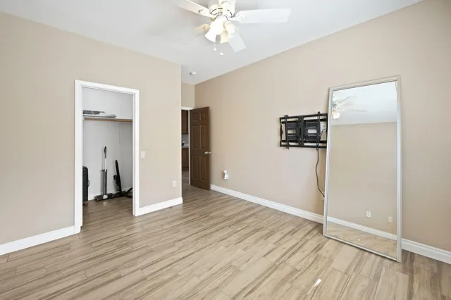 a view of an empty room with wooden floor