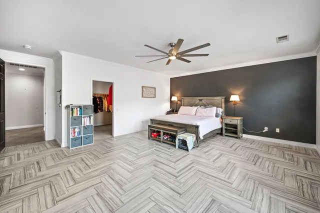 a bedroom with a bed and a chandelier