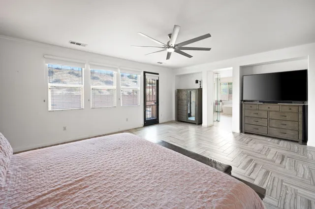 a view of an empty room with a window and a flat screen tv