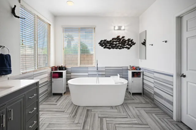 a spacious bathroom with a bathtub and a sink