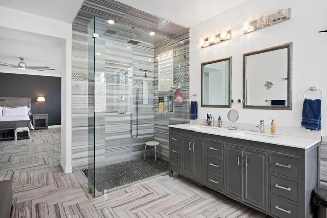 a spacious bathroom with double vanity and a mirror