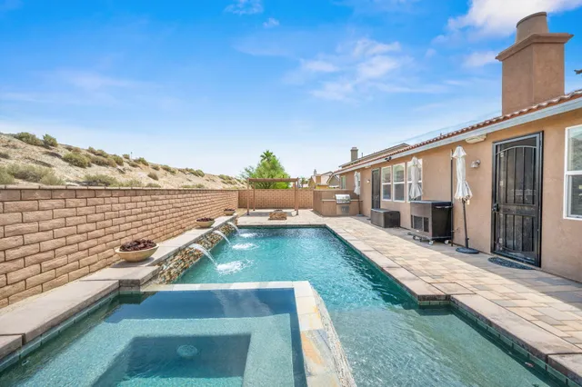 a view of a swimming pool with a lounge chair