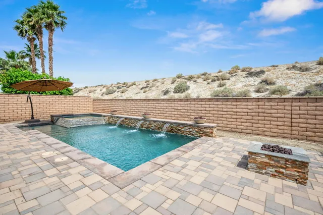 a view of a terrace with chairs and wooden fence