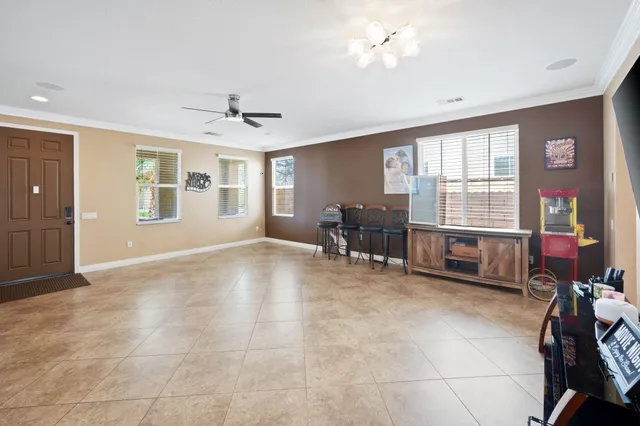 a living room with furniture and large windows