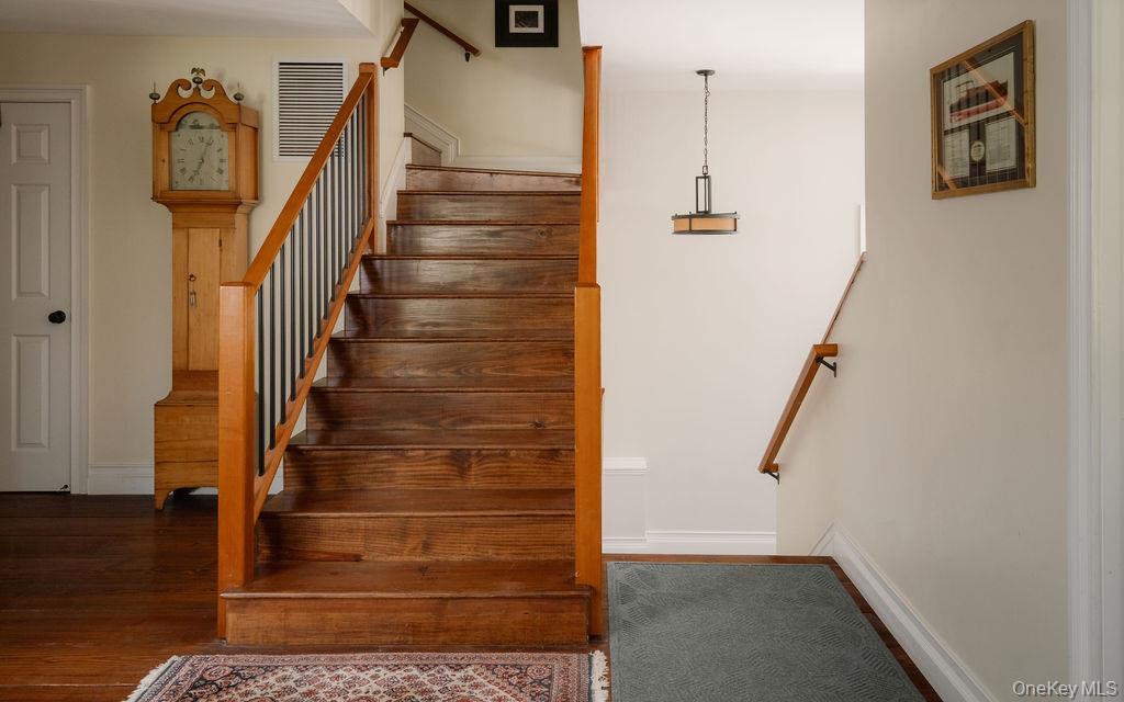 92 Fiddlers Bridge Road Staatsburg, NY 12580 - Photo 14 of 32 Hardwood staircase with natural wood treads and risers, complemented by a wood handrail and black metal balusters