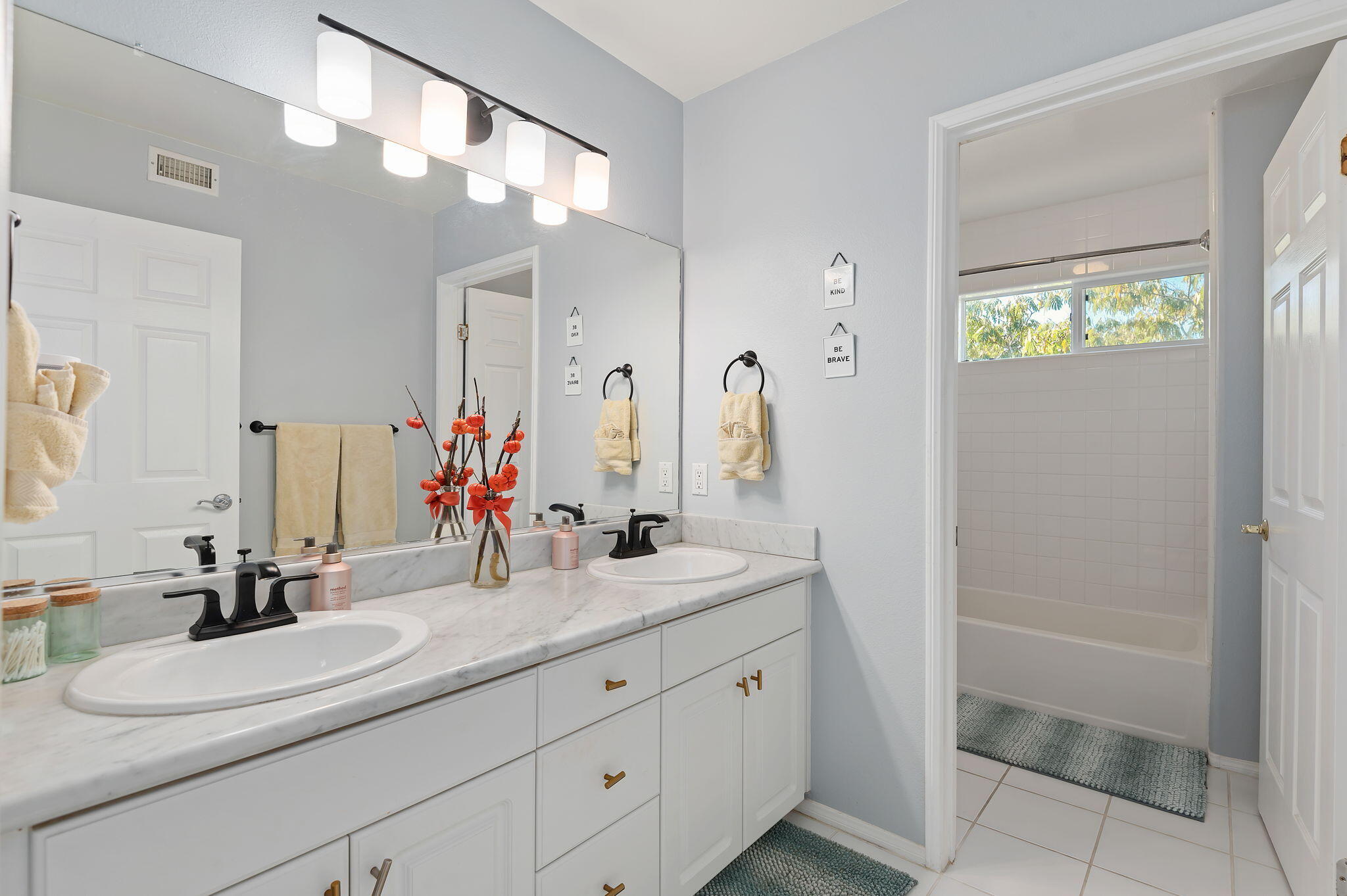 7818 Day Road Goleta, CA 93117 - Photo 13 of 24 a bathroom with a double vanity sink mirror and shower