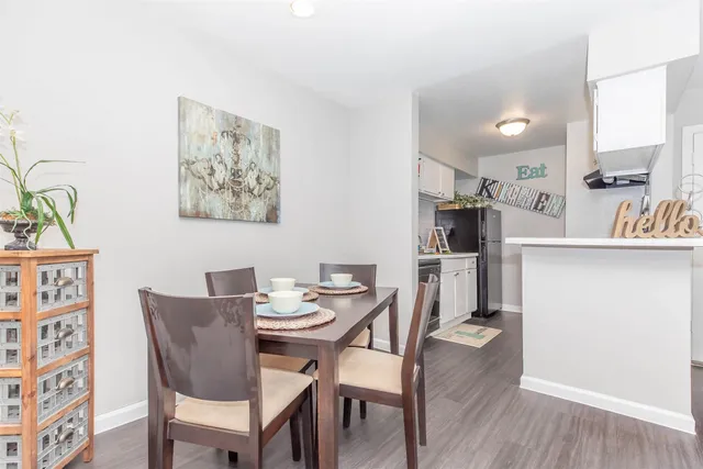 a view of a dining room with furniture and wooden floor