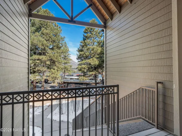 a view of a balcony with a small yard