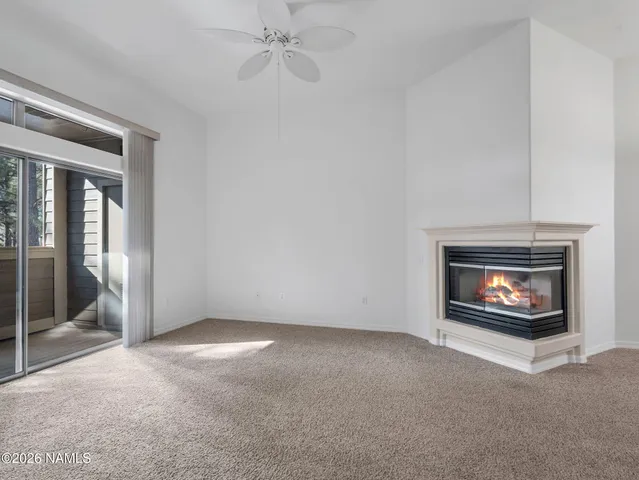 a view of an empty room with a fireplace