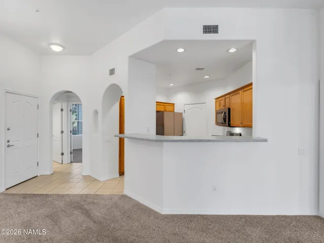 a kitchen with stainless steel appliances granite countertop a stove and a refrigerator
