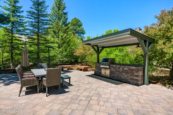 a view of a patio with table and chairs potted plants with wooden fence