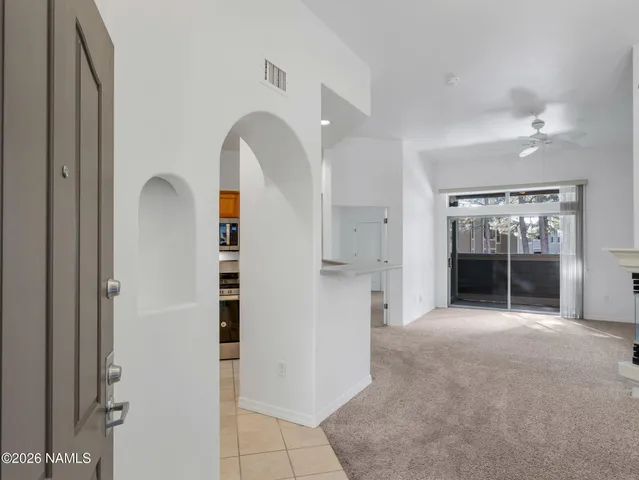 a view of a room with large windows and cabinet